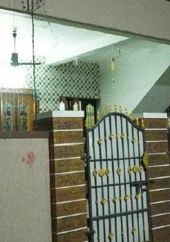 Residential entrance with iron gate and stone pillars